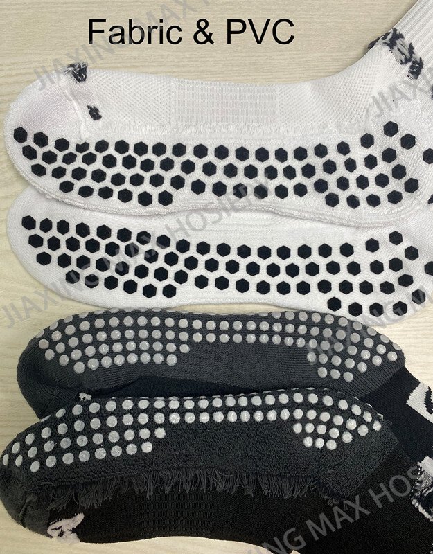 Comparison of fabric and PVC grips on the soles of black and white socks.