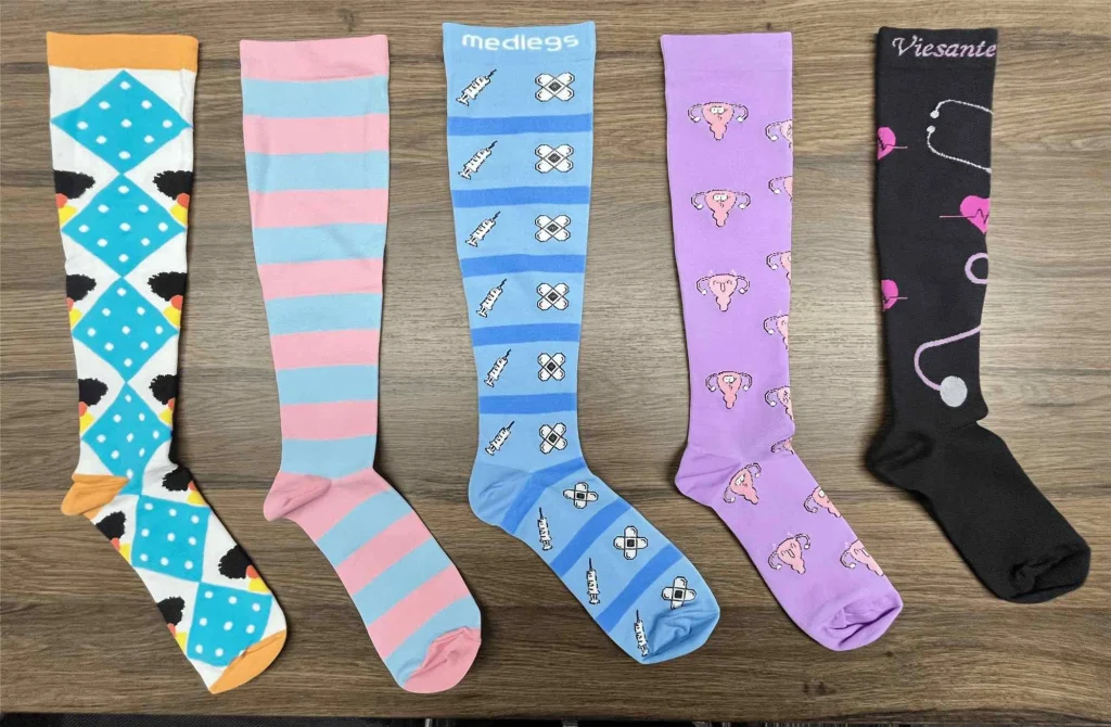 Five colorful medical compression socks in various patterns.