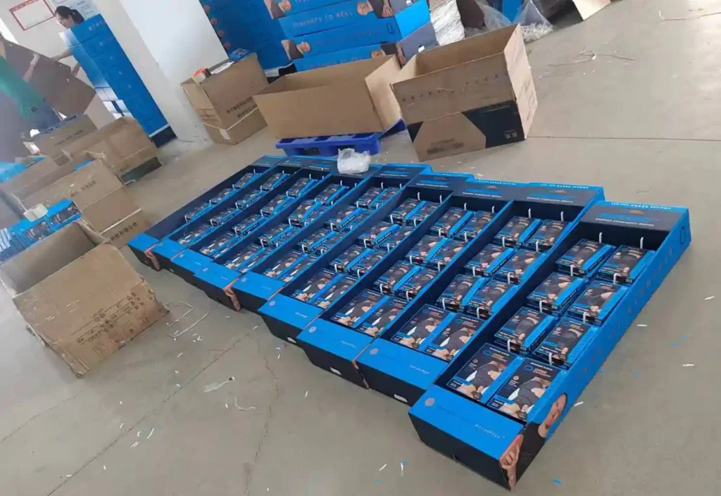 Shelf-ready packaging for socks displayed on a warehouse floor.