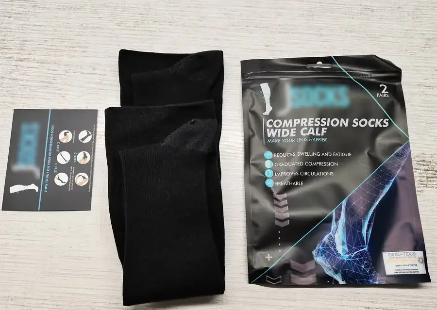 Color cards for socks, including a pair of black compression socks.