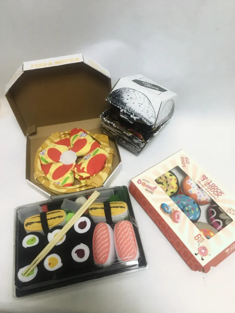 Creative sock packaging designed to look like a pizza, donuts, and sushi.