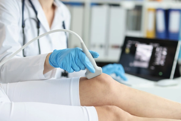 Doctor examining a patient’s lower leg to check for circulation problems and risks of sleeping in compression socks
