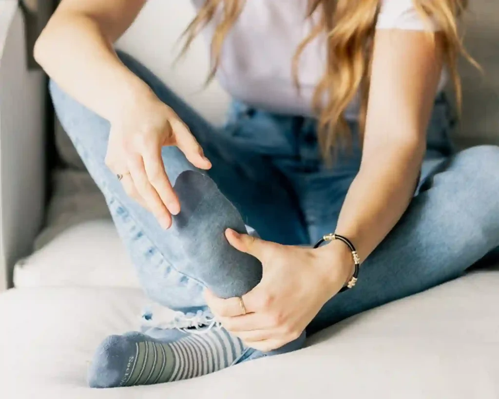 A person wearing a striped compression sock for neuropathy.