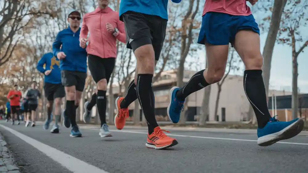 running compression socks for men and women on a morning jog in a city park