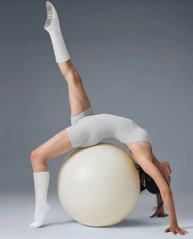wearing pilates socks on a yoga ball