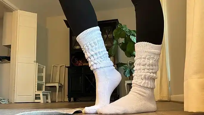 Slouch socks in white, worn scrunched with black leggings.