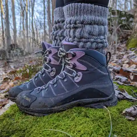 Slouch socks with boots for a cozy outdoor hiking look.