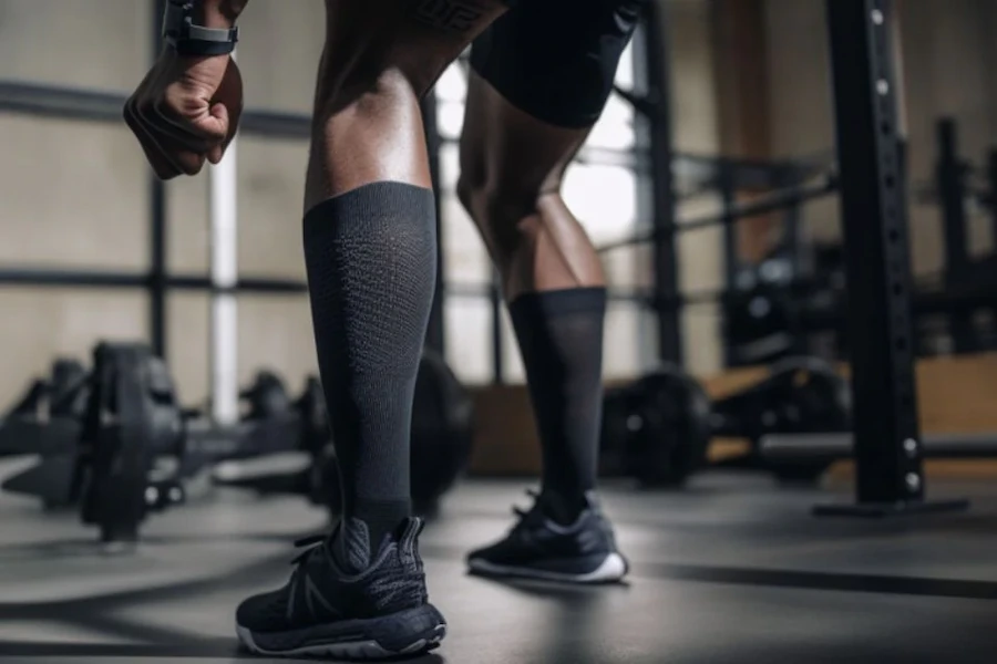 Compression socks worn by an athlete in a gym setting.