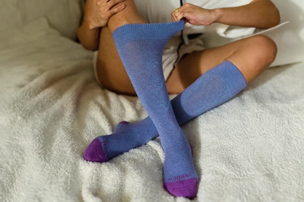 Diabetics weaing compressin socks on bed during nighttime