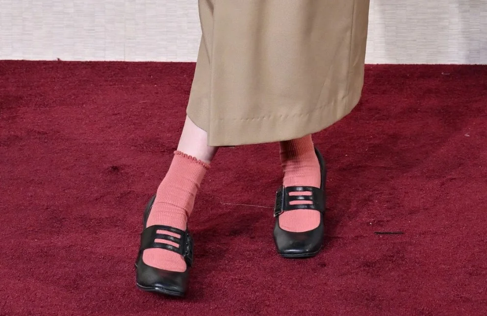 Socks and sandals fashion with pink socks and black shoes.