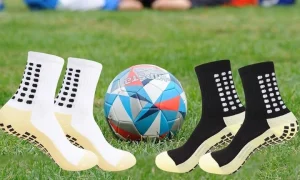 Grip socks for soccer shown on a player with a ball.