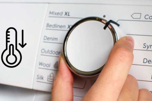 Close up of a laundry dryer control panel set to low heat, showing the gentle or wool setting for delicate fabrics