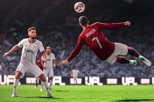 A soccer player wearing a red jersey jumps to hit a ball with his head.