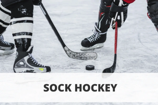 Hockey player wearing socks with shin guards, demonstrating how socks help protect feet and legs during play