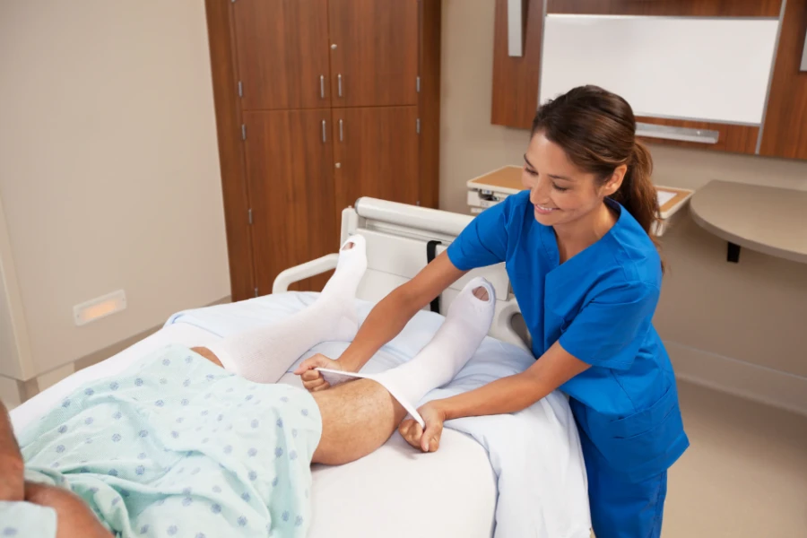 Patient recovering in hospital bed wearing compression socks