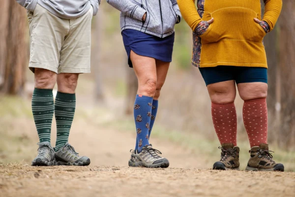 Photo of person walking wearing knee high compression socks
