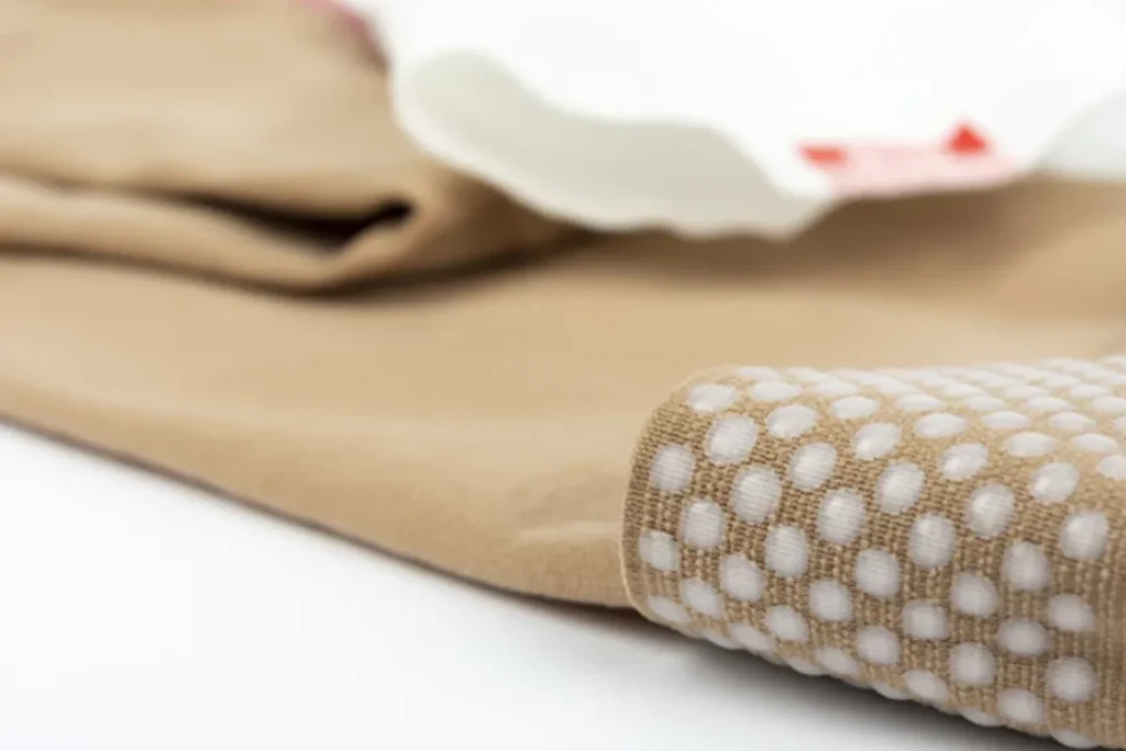 Compression socks for after surgery: A beige anti-embolism stocking with white grip dots for post-operative recovery.