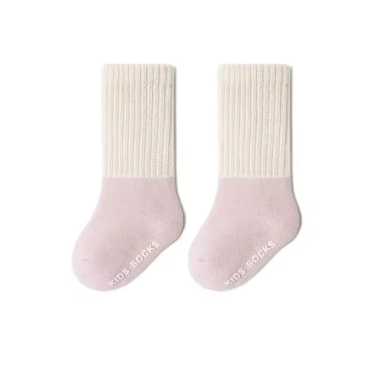 Full foot baby grip socks in a pink and white two-tone design.