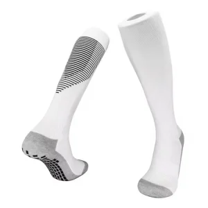 White football grip socks with black and grey anti-slip pads for enhanced traction and stability.
