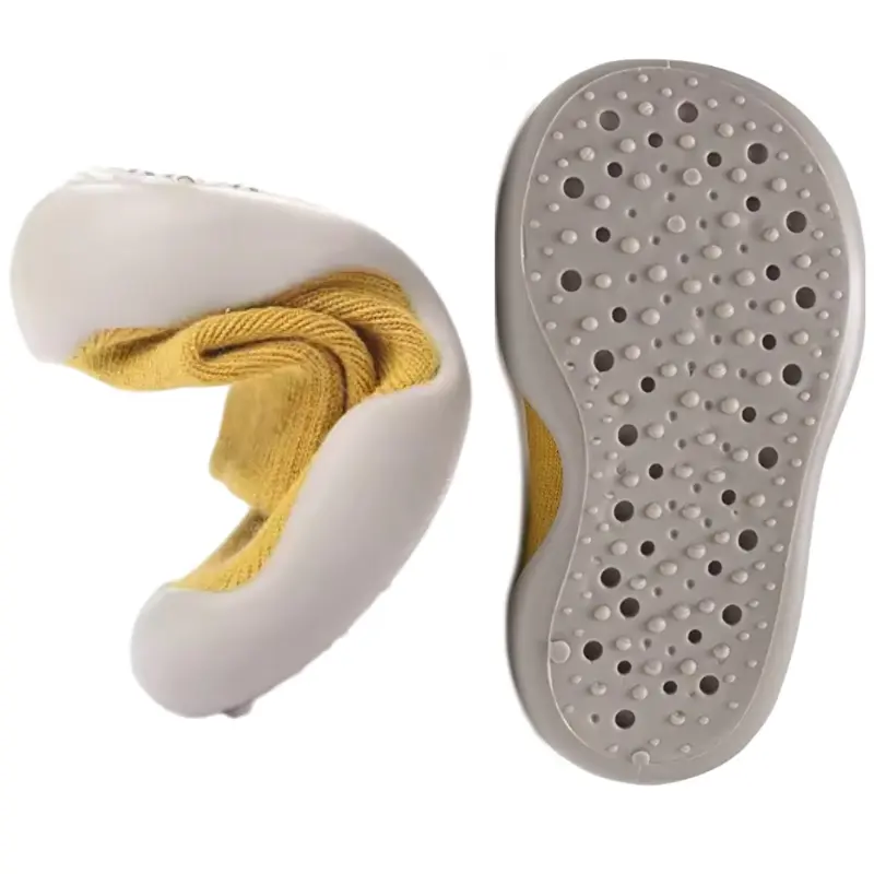 Close-up of baby shoe sock’s TPU non-slip sole with soft textured grip surface