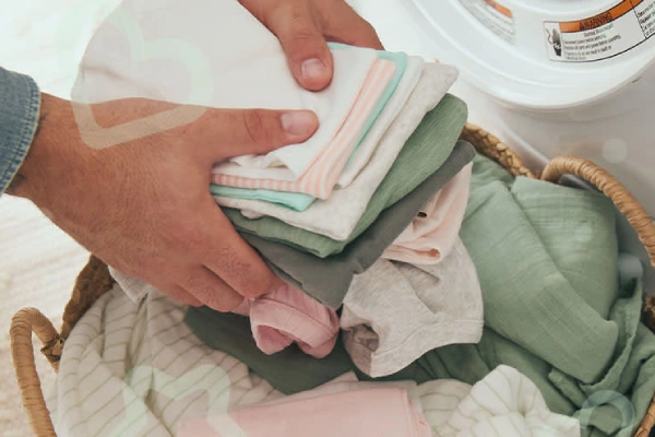 Care and maintenance of infant socks: folding clean laundry.