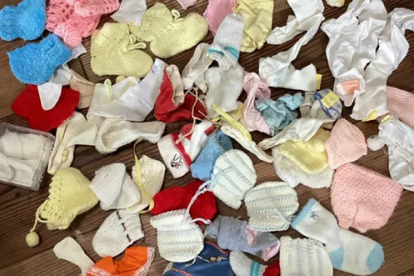 Different types of baby socks in various colors and materials displayed.