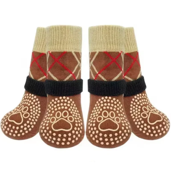 Four brown dog grip socks with red and beige argyle patterns.