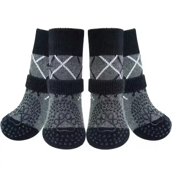 Four grey and black dog socks with grip and an argyle pattern.