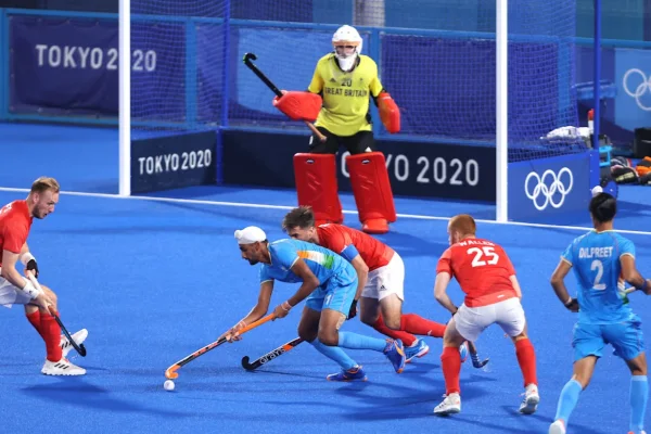 a male hockey player wearing hockey shin socks from the Indian team