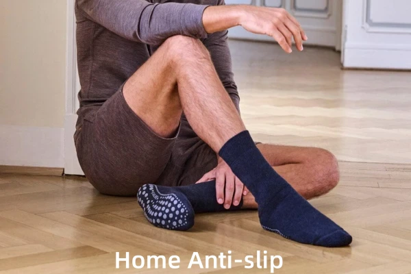 man wearing mental hospital grip socks on a wooden floor, close-up shot.