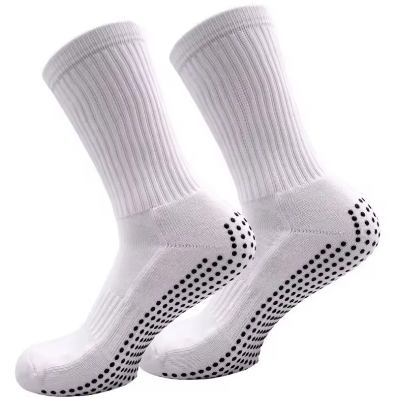 Pair of white mental hospital grip socks with non-slip dots on the sole.