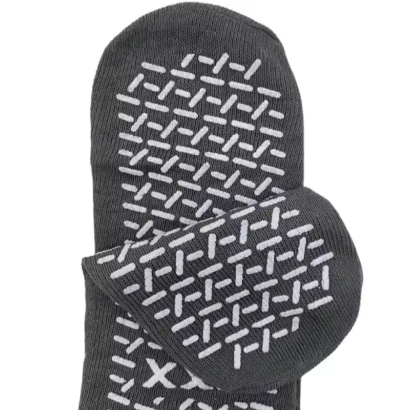gray non-slip hospital socks with white gripper treads on the soles.