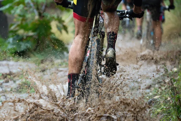 Riding across mud road with quick dry cycling socks