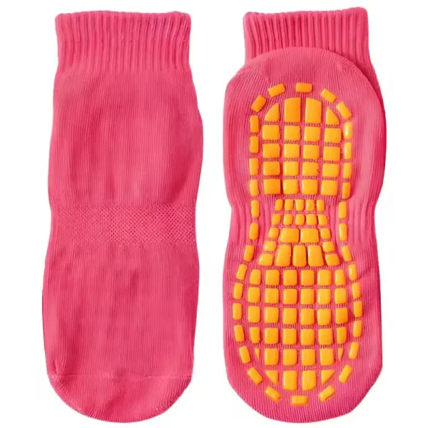 pink trampoline grip socks with yellow anti-slip rubber pads on the sole