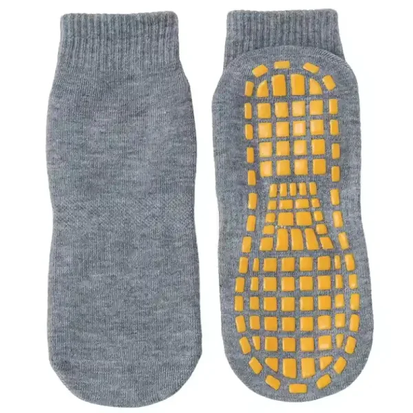 Trampoline park socks for adults in grey with yellow non-slip grip pads.