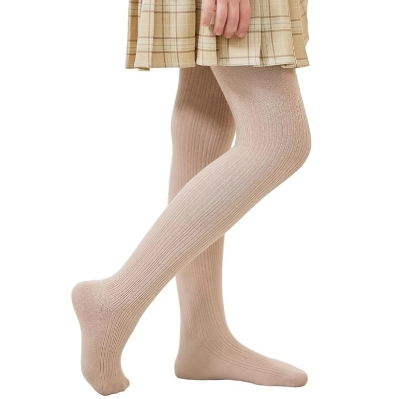 Little girl wearing fleece-lined school tights and a pleated plaid skirt
