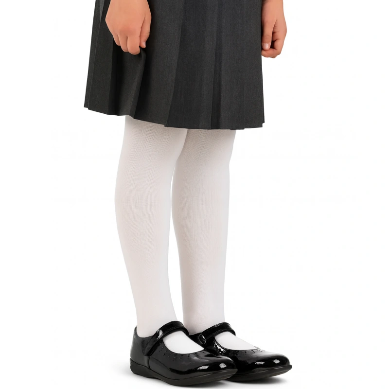 Girl's legs with white ribbed school tights and black shoes