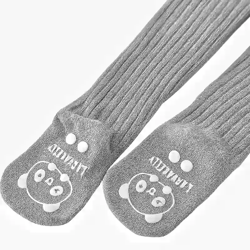 An up-close shot of a pair of kids' tights with Non-Slip Silicone Grip Dots on the sole.