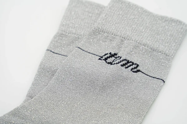 Cheer socks with woven metallic threads and printed logos as safe decoration alternatives