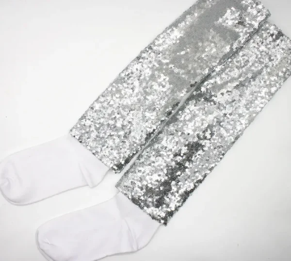 Close up of socks decorated with sequins and glitter showing loose, unsafe elements