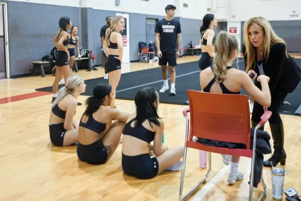 Coach reviewing decorated socks to ensure durability, safety, and team uniformity