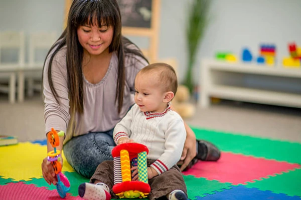 Infant wearing non slip socks in a daycare playroom, symbolizing safety, comfort, hygiene, and parent trust