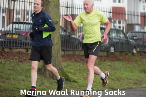 Two male runners, one young and one older, wearing Merino wool running socks in a park.