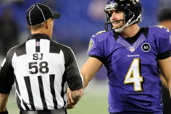 Referee checking football player’s uniform for leg sleeve and sock compliance