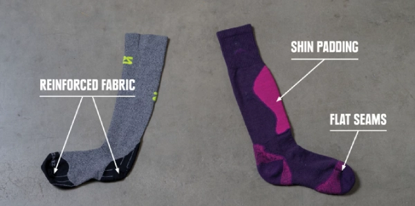 Thin vs. thick skiing socks with reinforced fabric, shin padding, and flat seams.
