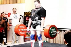 Weightlifting athlete competing while wearing both knee sleeves and deadlift socks for joint support and shin protection