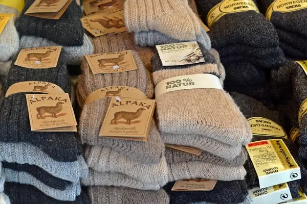 Wool socks display on store table — different types of wool socks for buyers to compare materials and quality