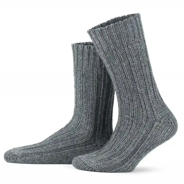 a pair of dark gray ribbed alpaca wool socks standing upright