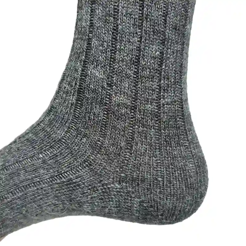 Detailed product view of the heel and ankle of grey ribbed alpaca wool socks
