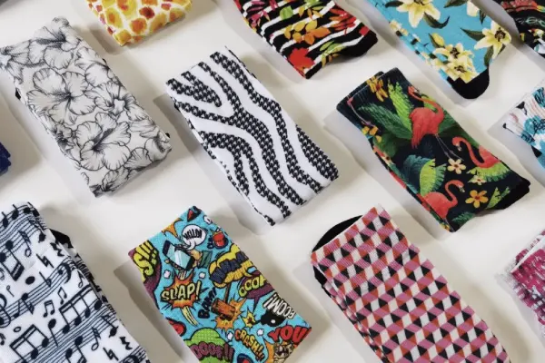 Colorful patterned socks, including musical notes and geometric designs, as examples of Digital Direct Printing Socks